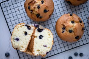 Delicious homemade blueberry muffins on a cooling rack, perfect for breakfast or dessert.